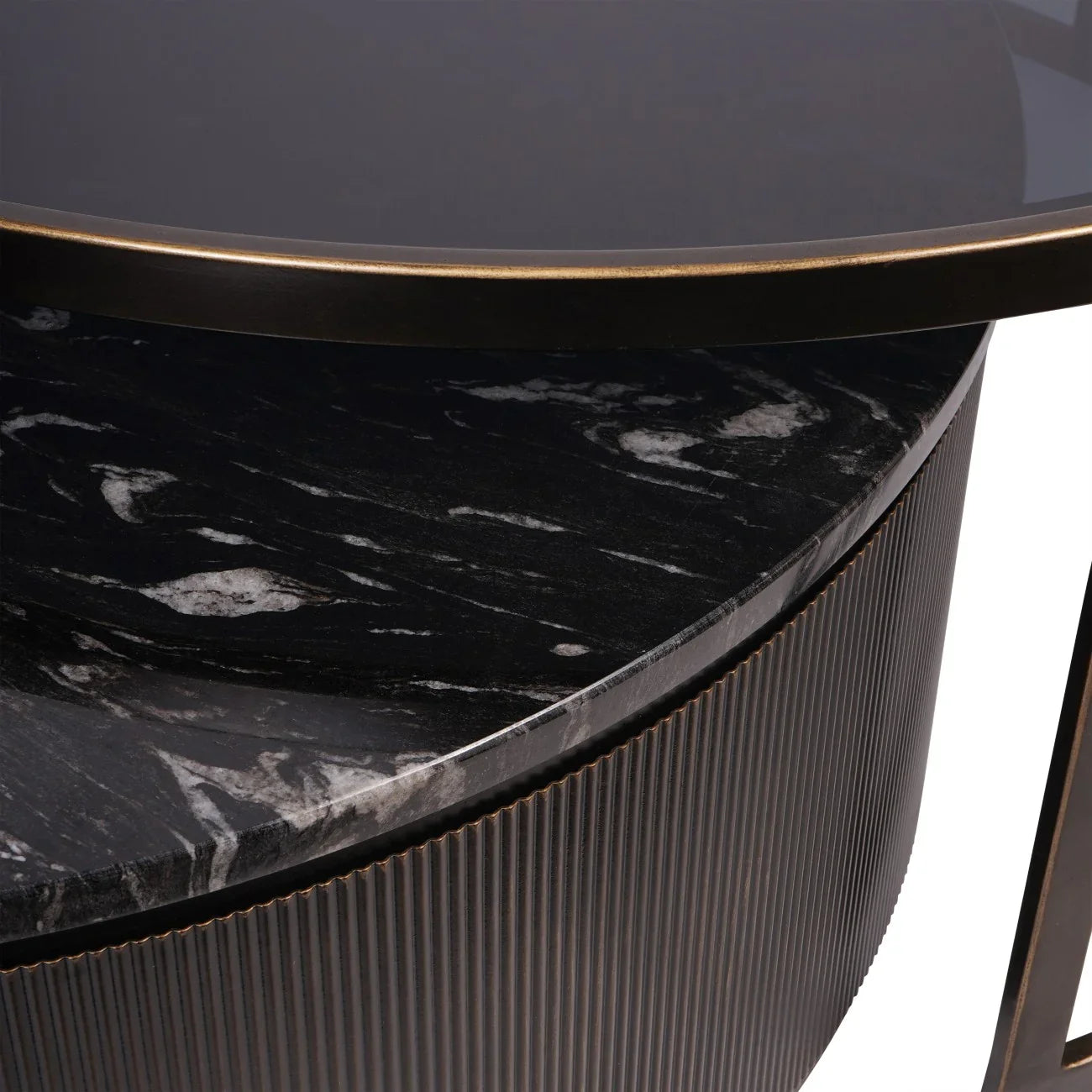 Black nesting coffee tables with marble texture and ribbed edge detail.