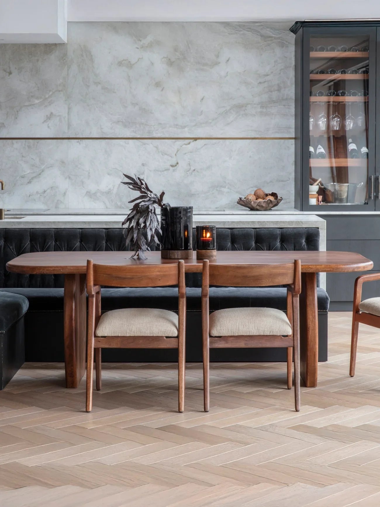 Wooden dining table with chairs in a modern dining room setting.