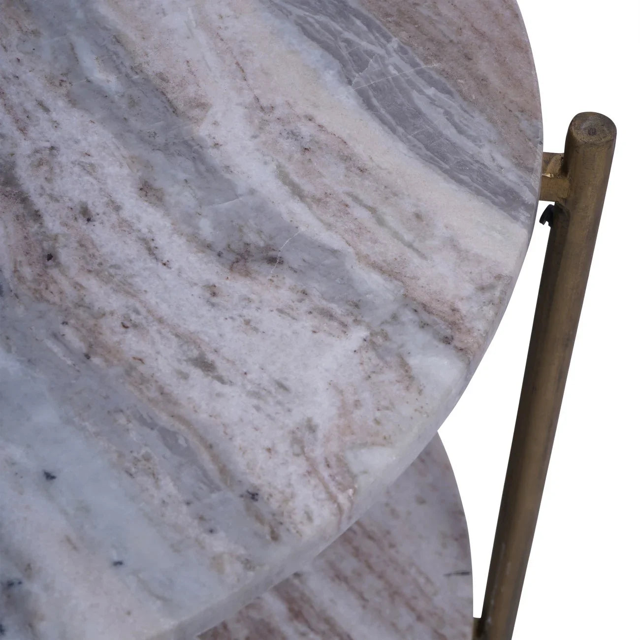 Close-up of round marble tabletop with natural veining and brass support.