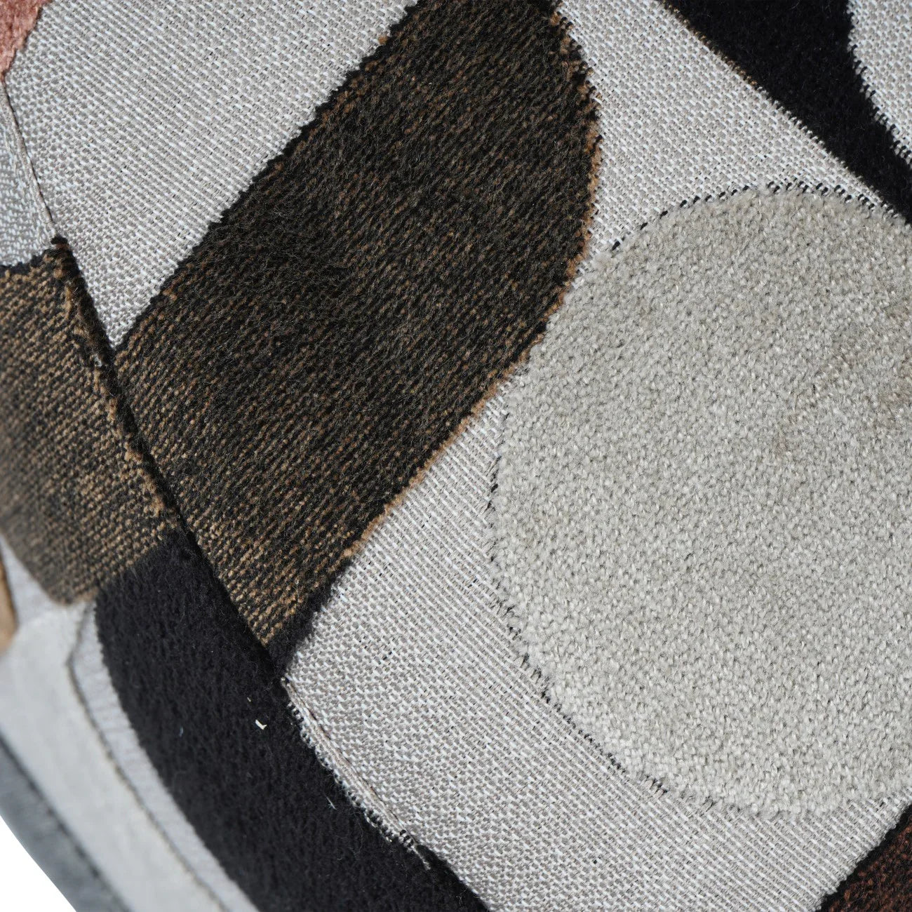 Textured close-up of patterned velvet fabric in earthy tones.