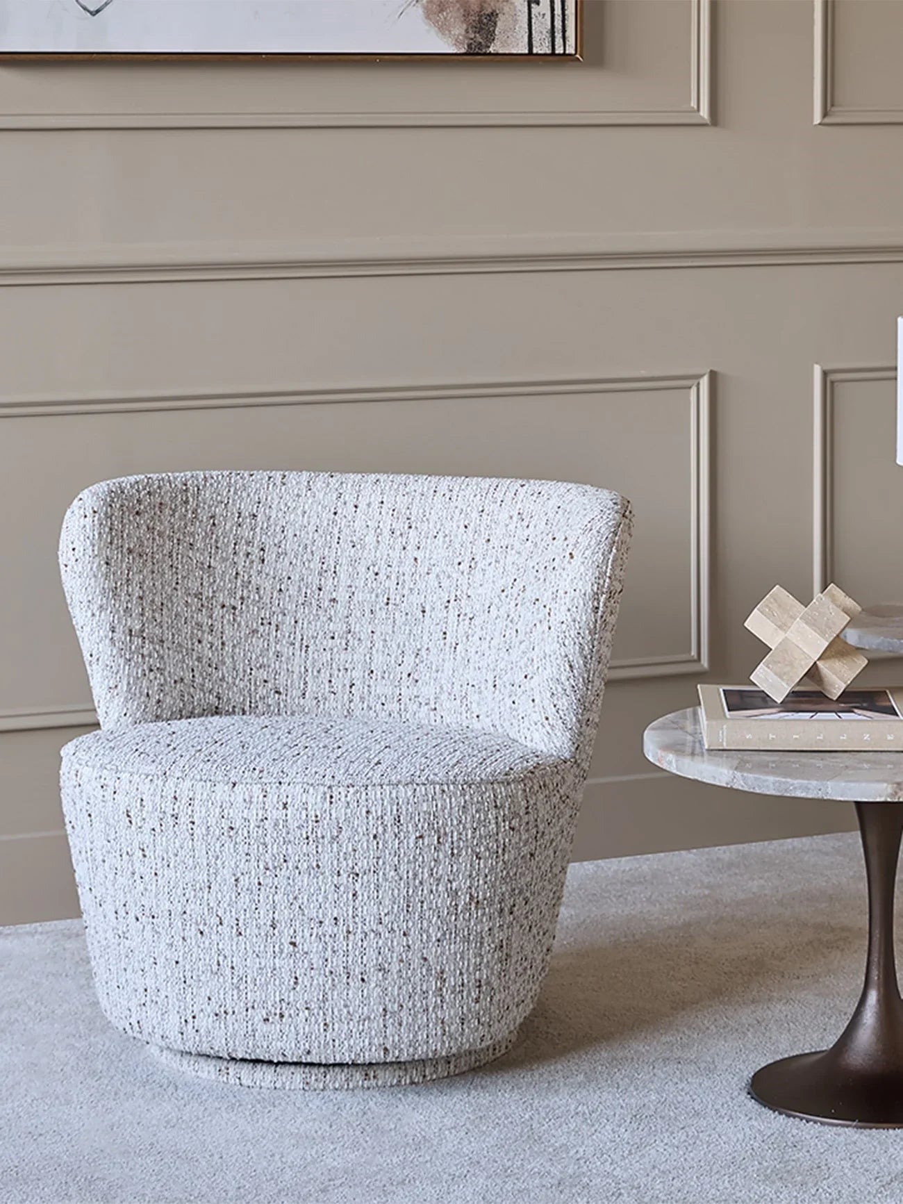Natural textured swivel chair in elegant living room setting.