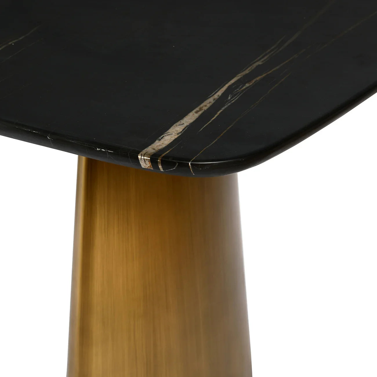 Black marble tabletop corner with brass leg detail.