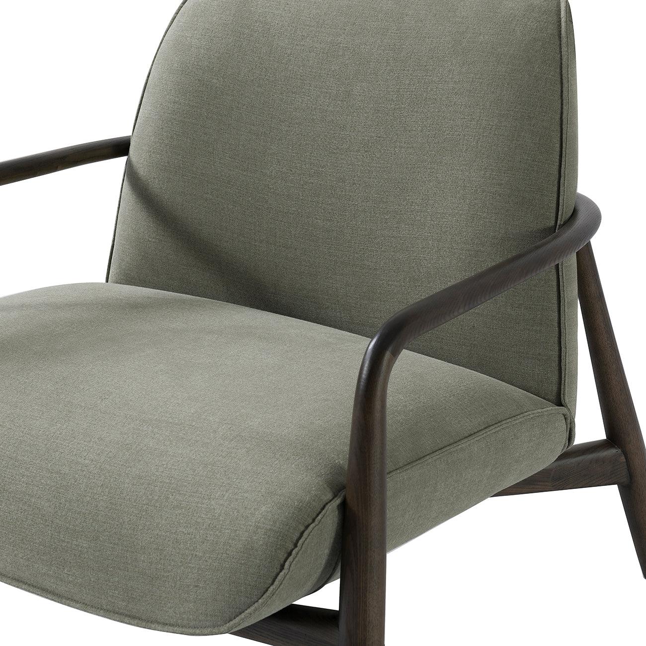 Green fabric chair with curved wooden arms and cushioned seat.