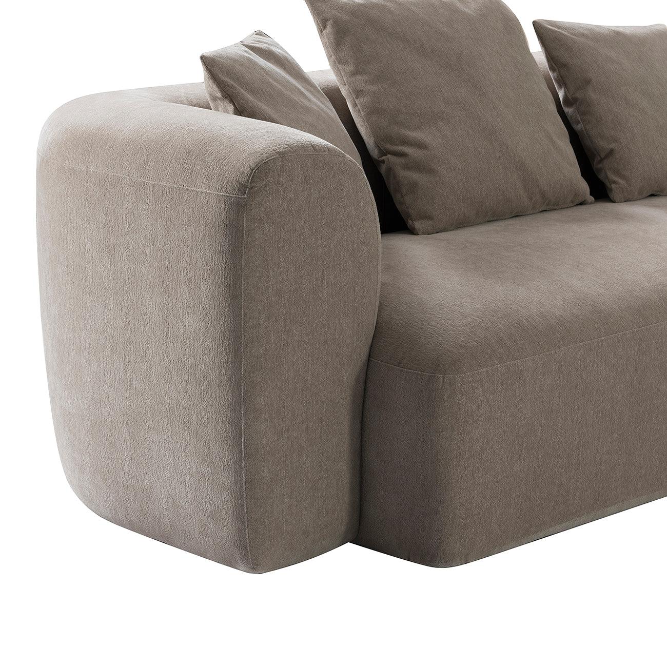 Taupe sectional sofa with plush cushions and rounded armrest design.