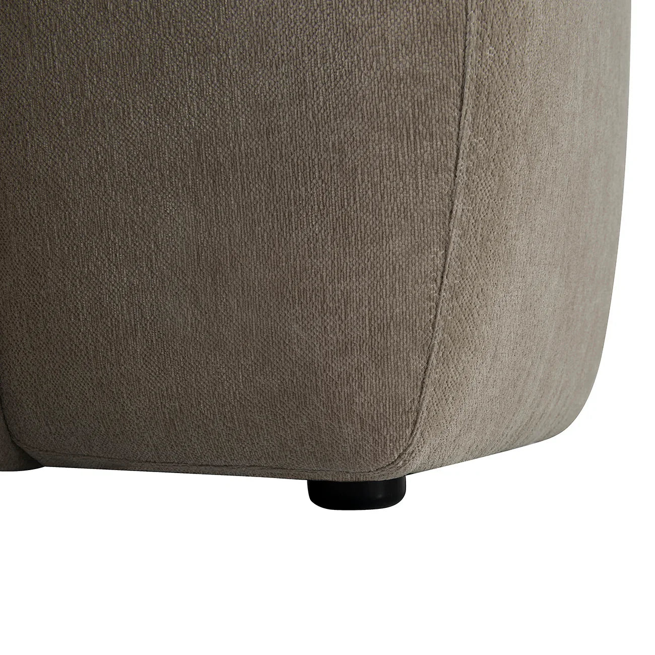 Natural fabric ottoman corner with detailed texture and subtle stitching.