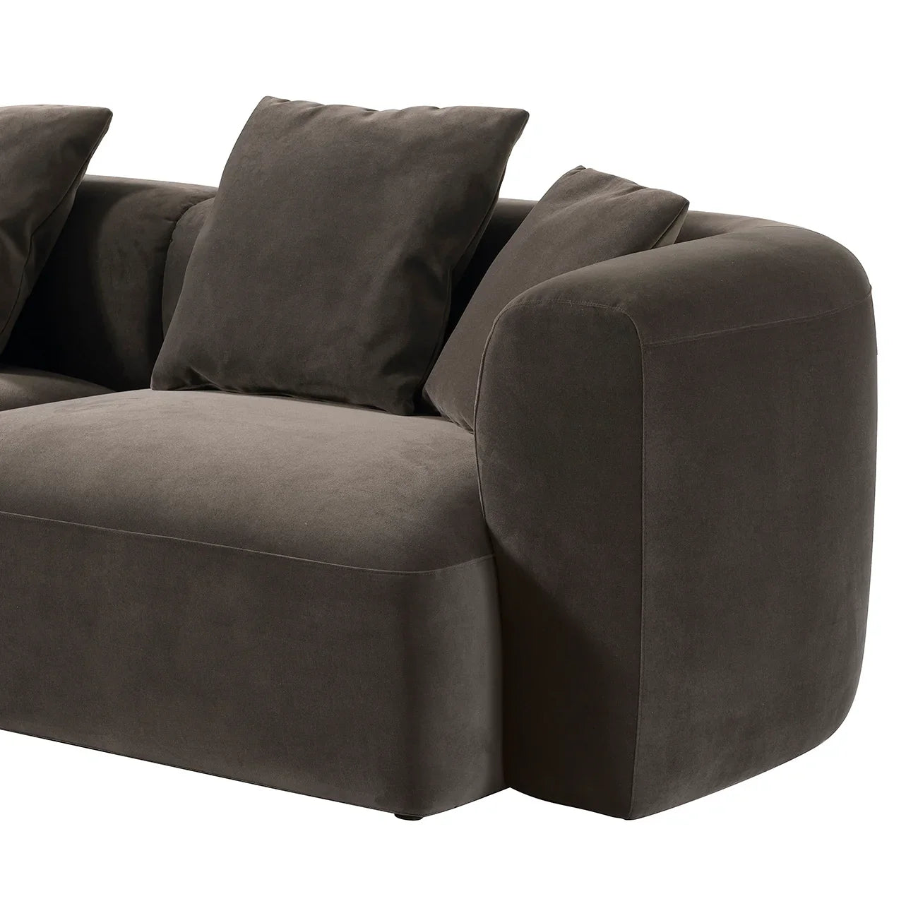 Brown velvet sofa with plush cushions and rounded armrest design.