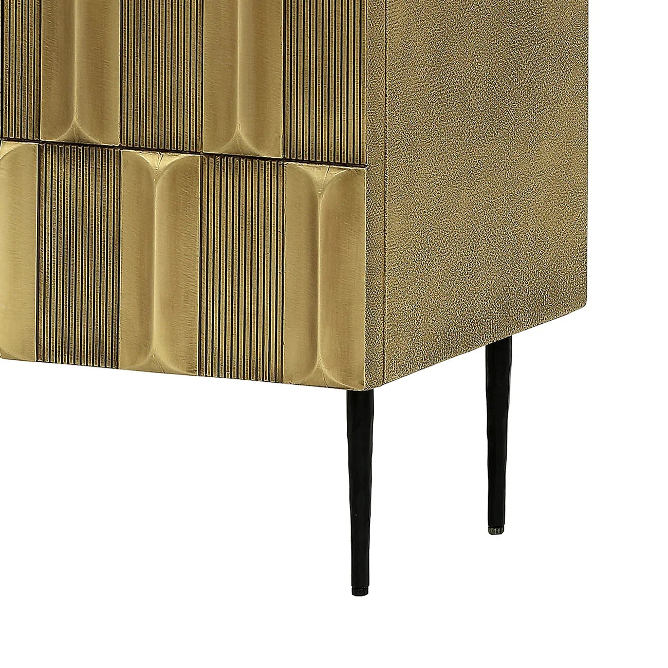 Brass cabinet corner with textured doors and sleek black legs.