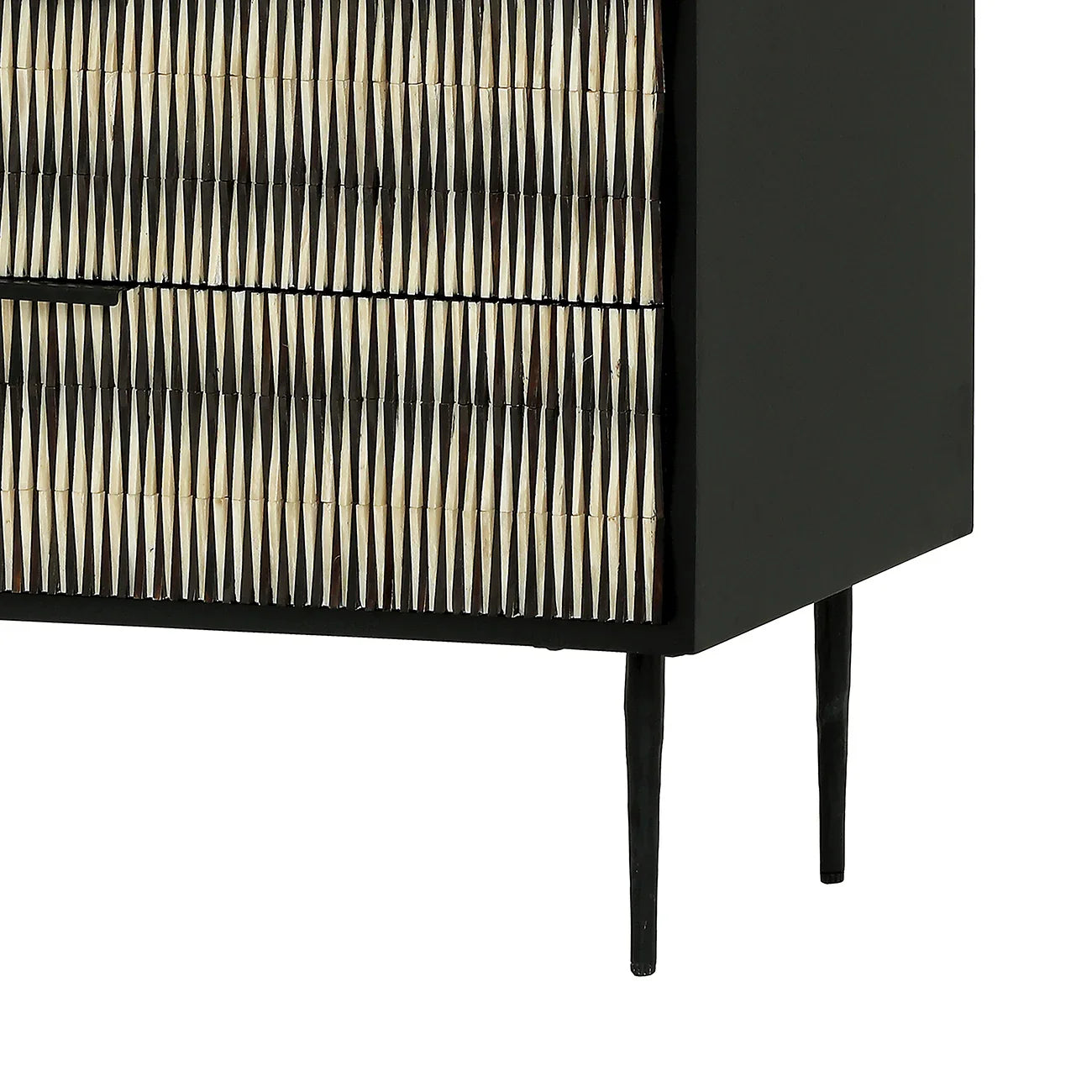 Black chest with intricate bone inlay pattern and slender legs.
