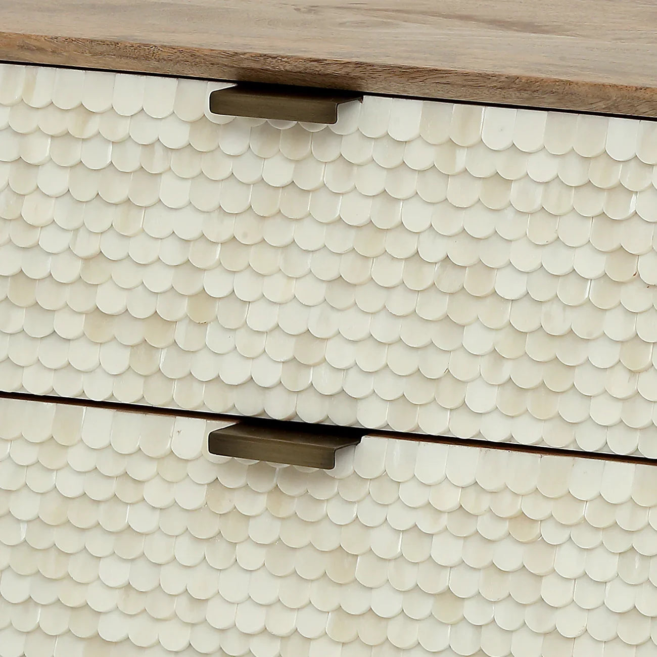Cream scalloped inlay detail on drawer front with metal handles.