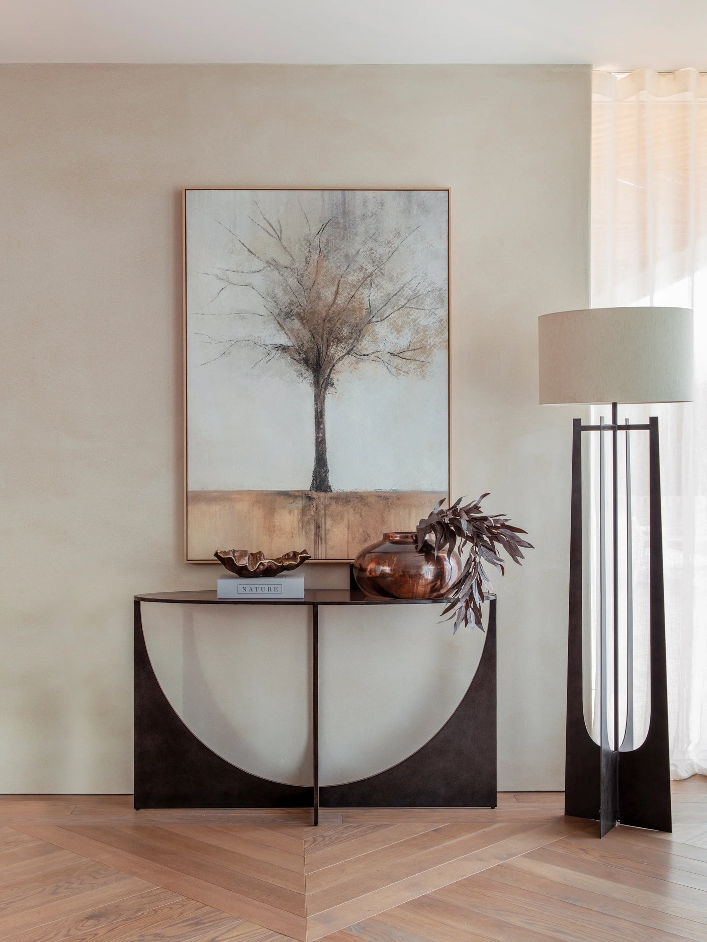 Dark wood console table with decorative items in a modern living room setting.
