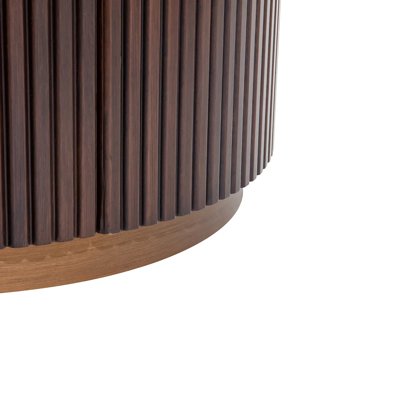 Dark wood chest corner with vertical grooves and rounded base.
