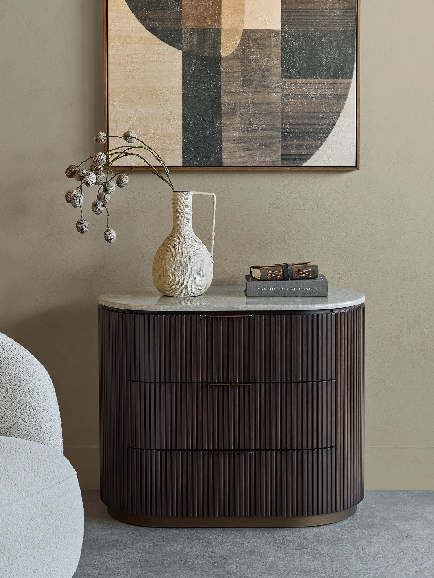 Dark wood chest with ribbed texture, styled in a modern room with art and decor.