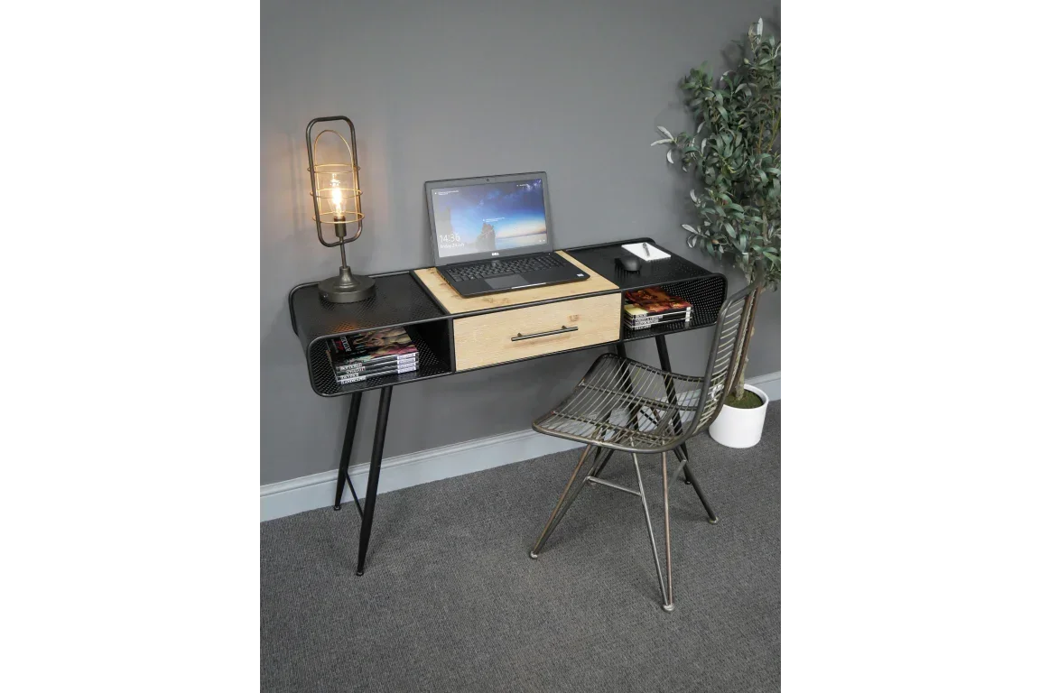 Black metal and wood desk with drawers, laptop, lamp, and modern chair in home office setup