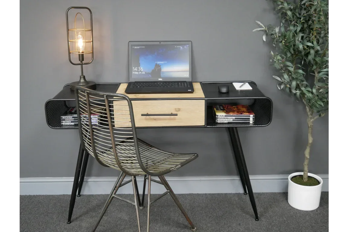 Modern black and wood office desk with metal chair, laptop, lamp, and books against grey wall