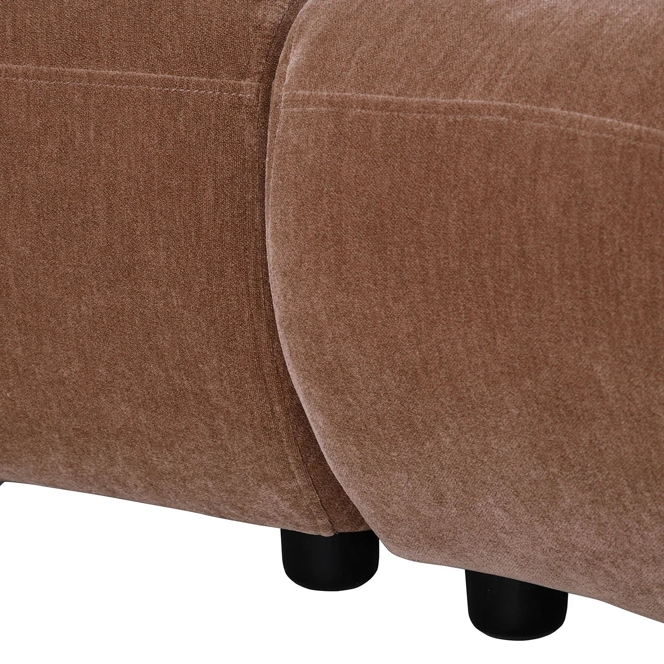 Mocha velvet sofa close-up showing smooth texture and rounded edges.