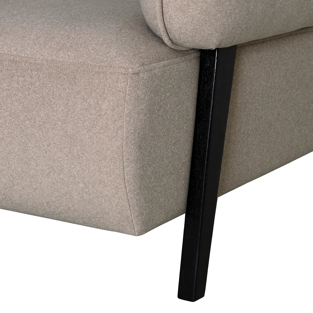Beige fabric chair corner with black wooden leg detail.
