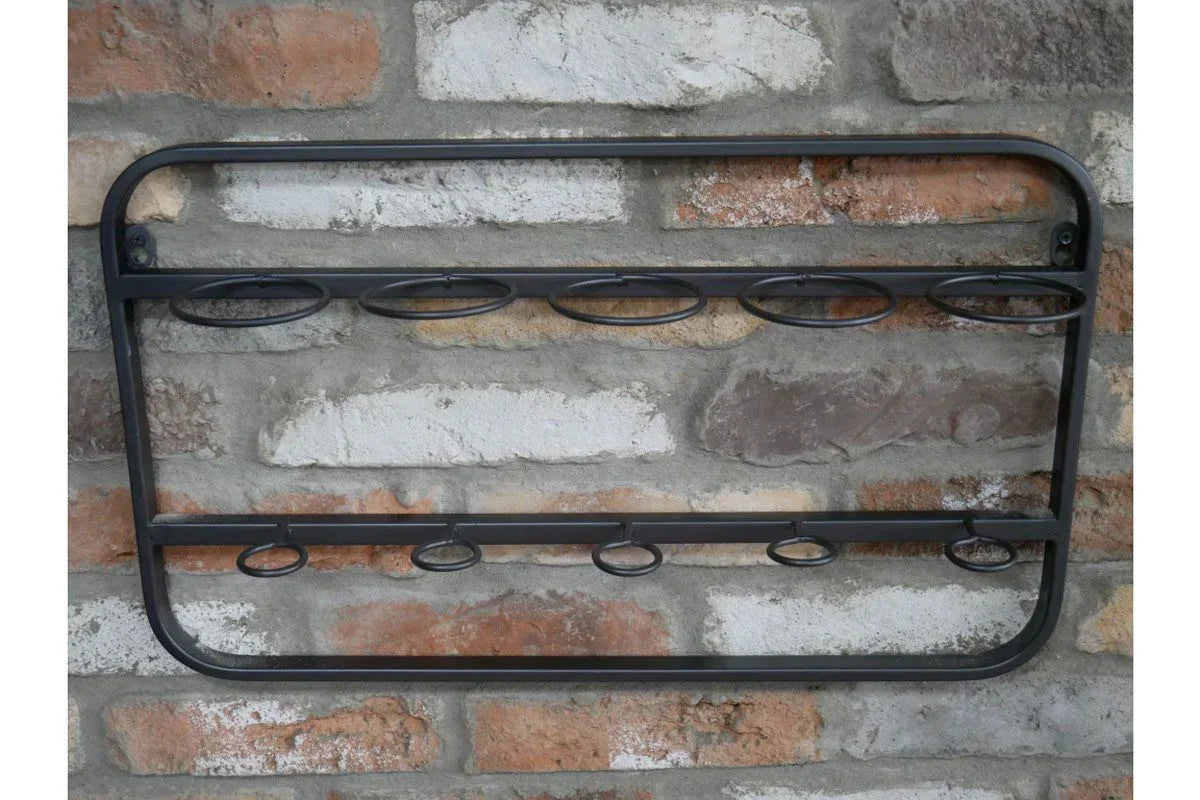 Black metal wall-mounted wine rack with bottle holders against brick wall