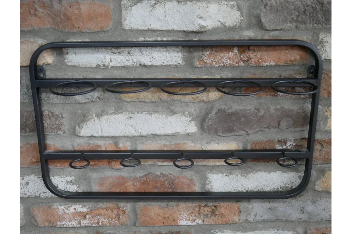 Wall mounted metal wine rack with two rows of bottle holders on brick wall