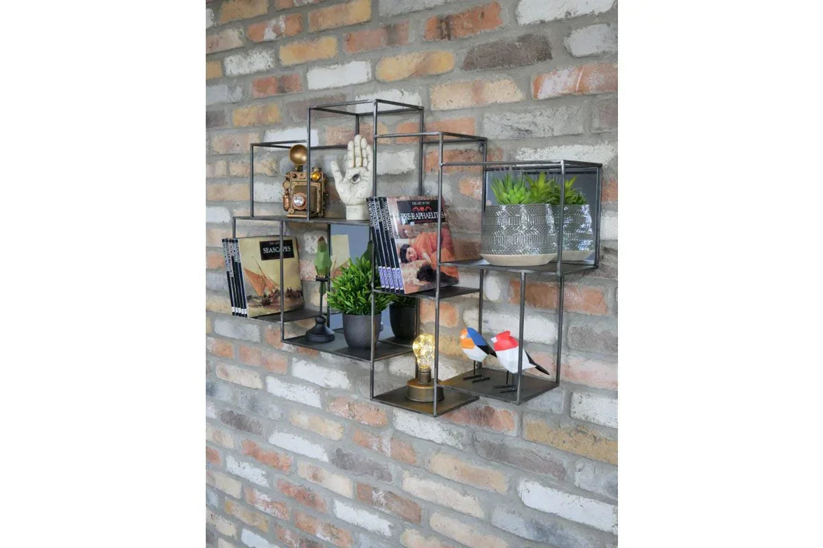 Industrial metal wall shelves with decor, books, potted plants and ornaments on brick wall