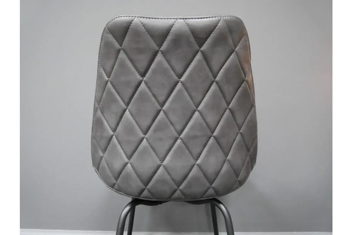 Grey dining chair with diamond stitched backrest and black metal legs