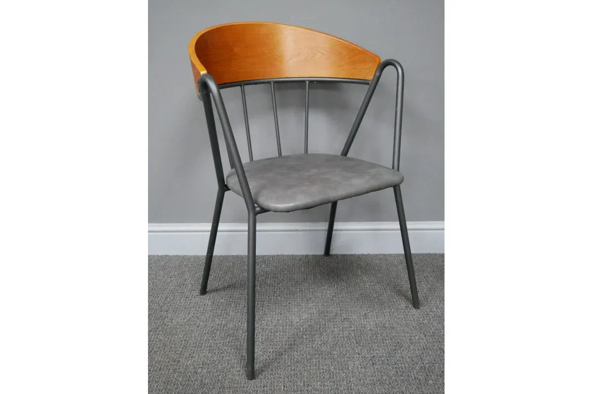 Modern dining chair with curved wooden backrest, black metal frame, and grey upholstered seat
