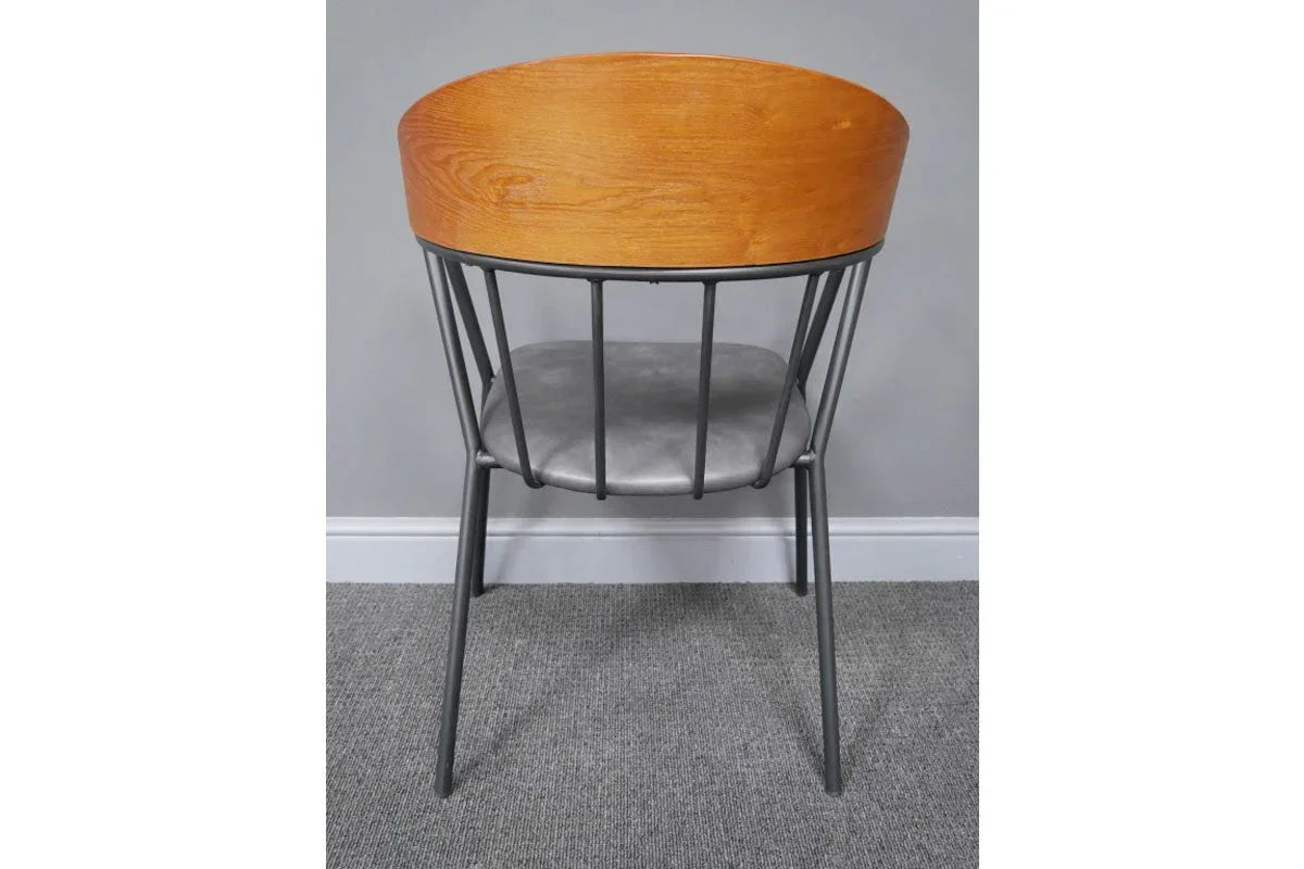 Modern dining chair with curved wood backrest, black metal legs, and grey cushioned seat