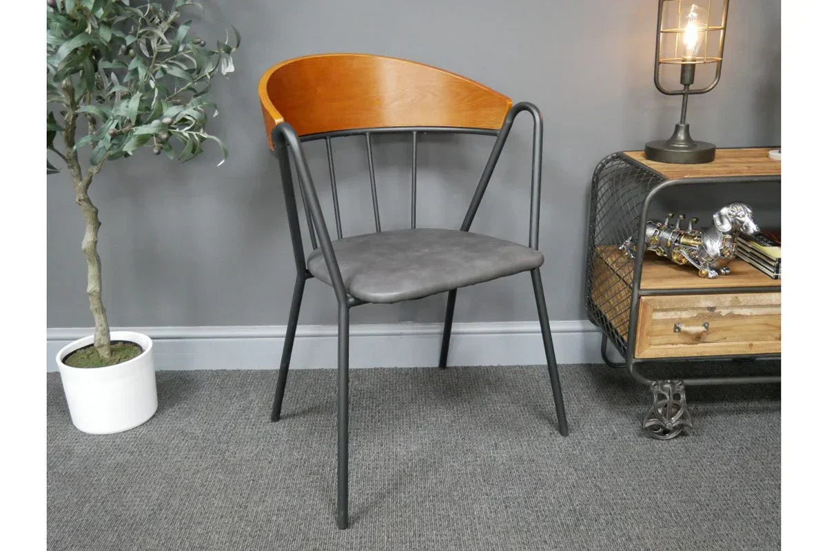 Modern dining chair with curved wood backrest and grey cushioned seat on black metal frame