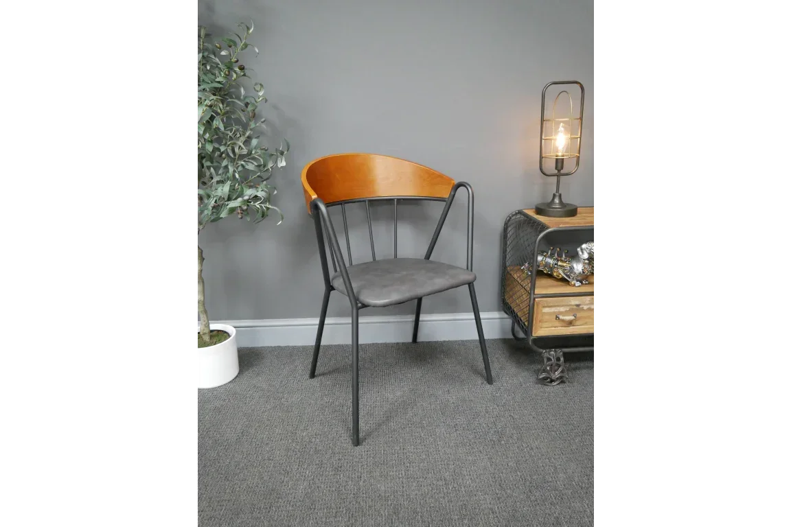 Modern dining chair with black metal frame, grey cushion and wooden backrest in living room