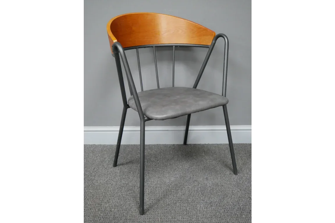 Modern dining chair with black metal frame, grey cushioned seat, and curved wooden backrest