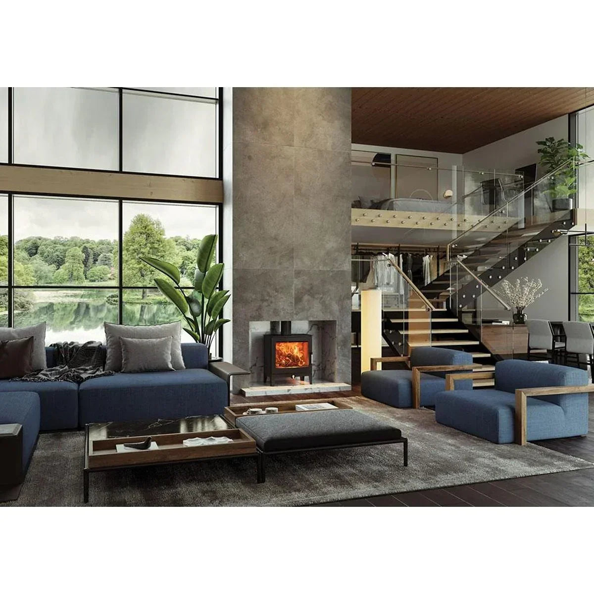 Modern blue sofa set and armchairs in spacious living room with fireplace and large windows