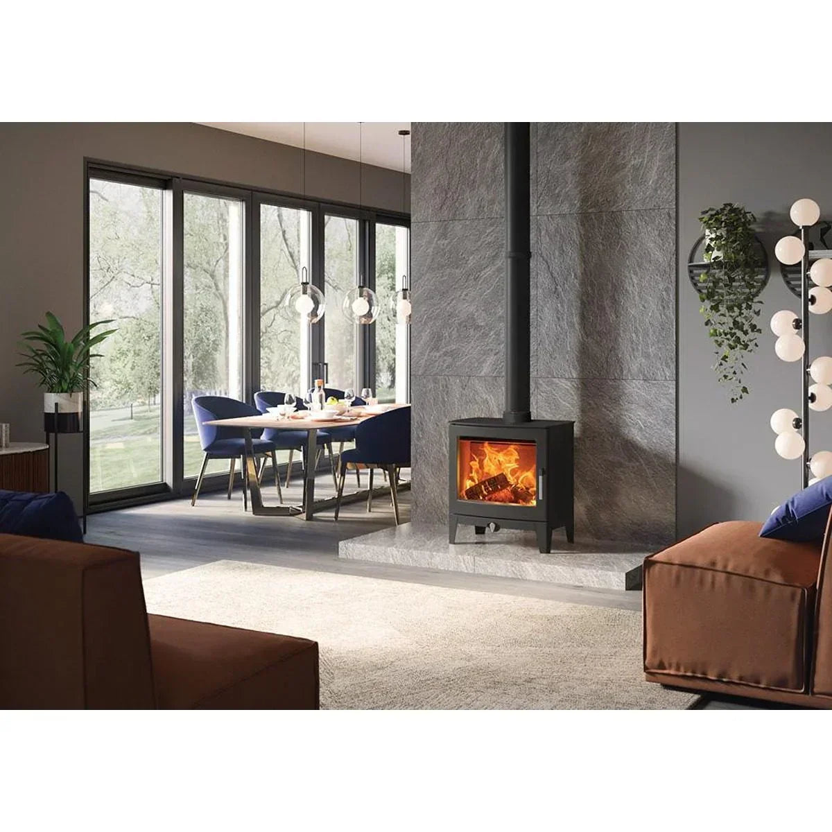 Modern wood burning stove on stone hearth in contemporary living room with dining area