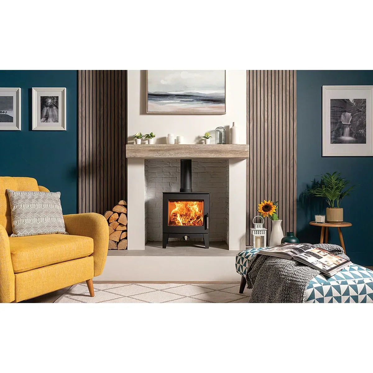 Modern living room with log burner stove, mustard armchair, and wood storage by the fireplace