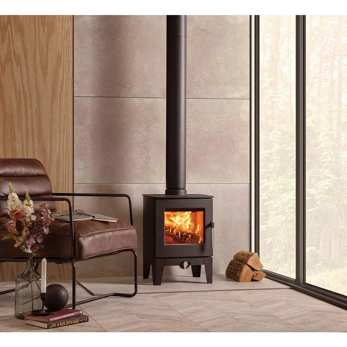 Black wood burning stove with flames beside leather chair in modern living room
