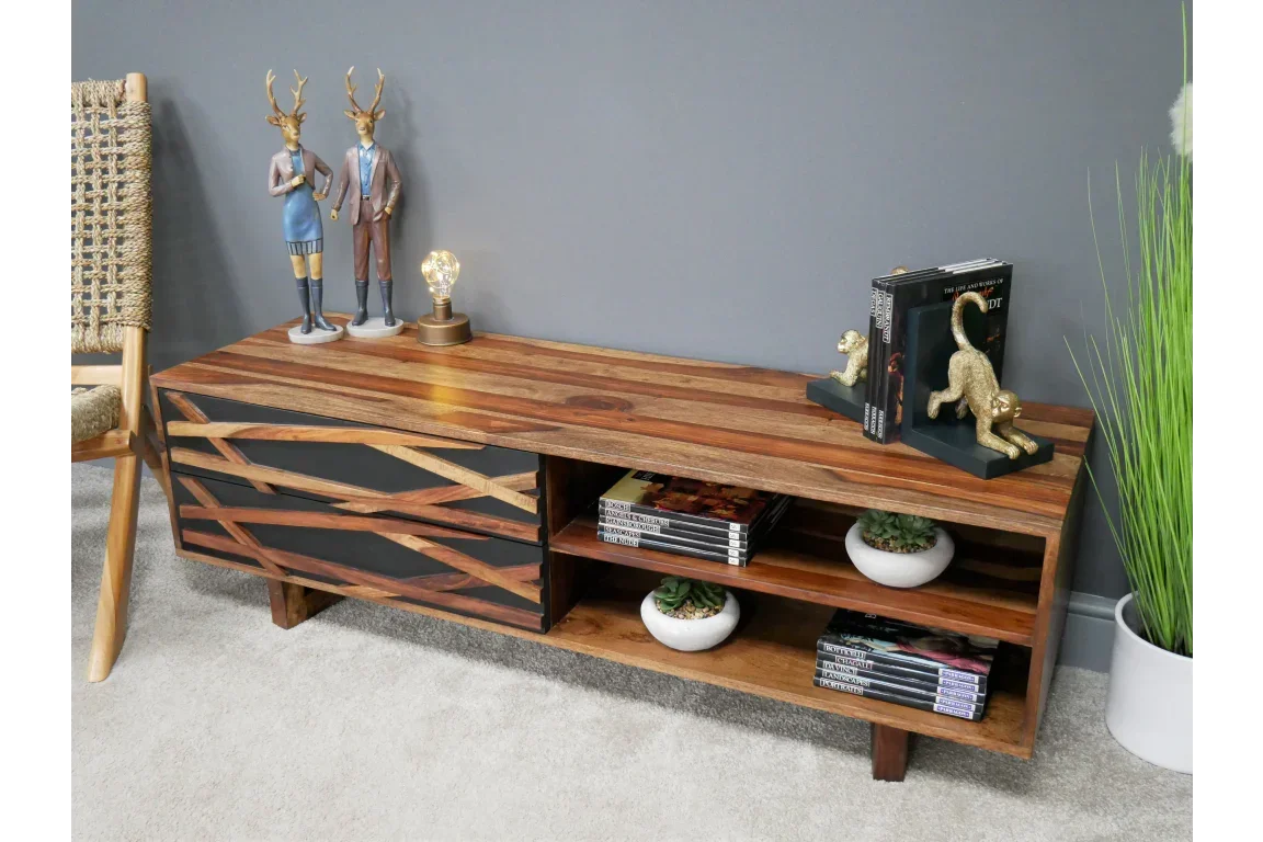 Solid wood TV unit with two drawers, open shelves, and decorative accessories on top