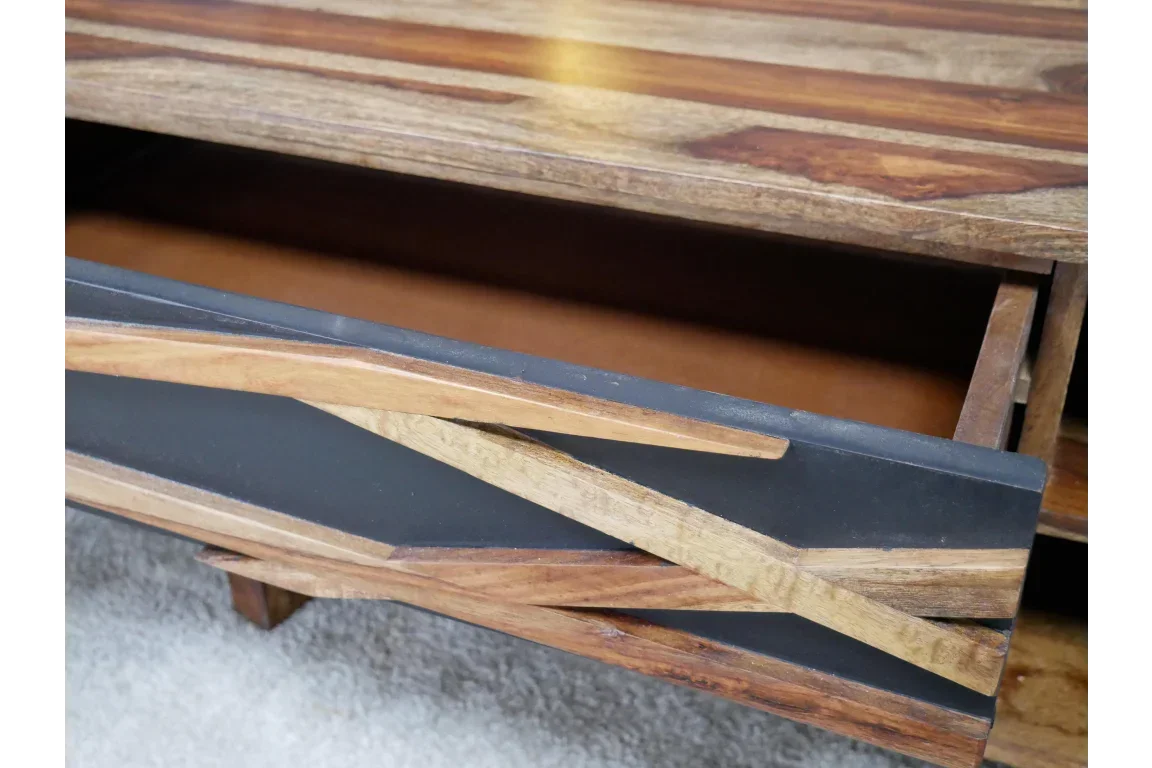 Close view of modern wooden coffee table with open storage drawer and geometric panel design