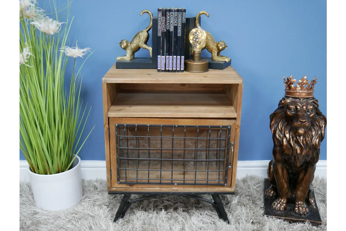 Industrial wood side table with metal grid door, books, and gold animal bookends