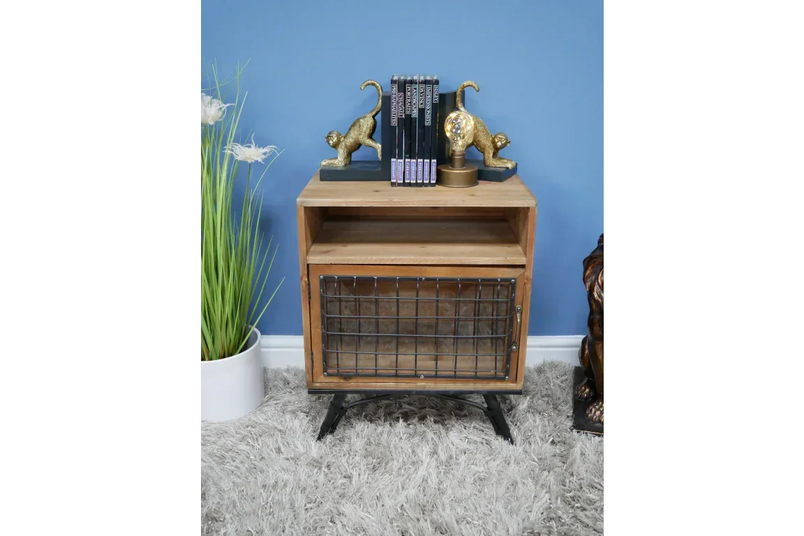 Industrial wood and metal bedside table with wire front and open shelf against blue wall