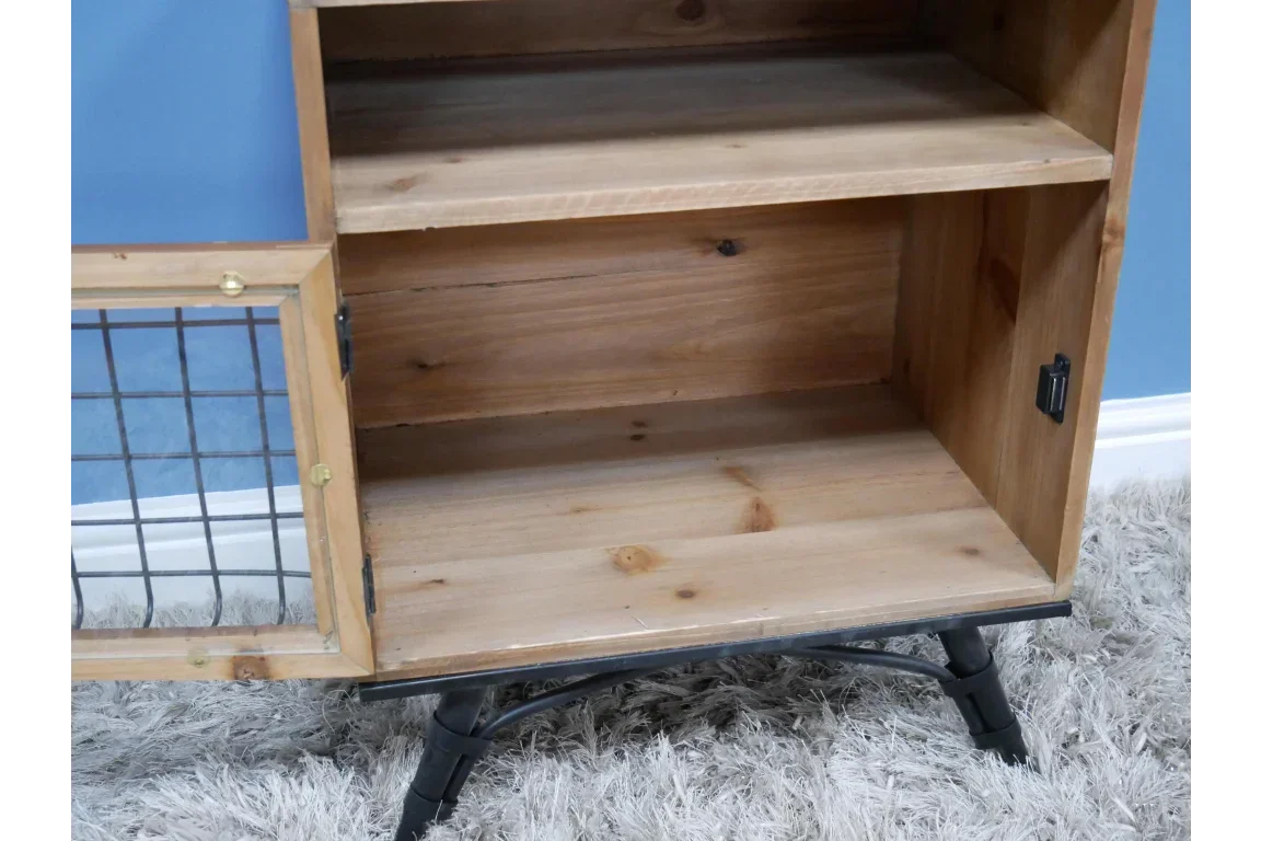 Wooden cabinet with open metal mesh door and black legs on a light grey rug