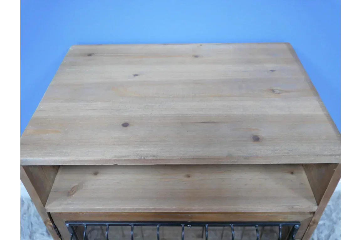 Light wood storage unit with open shelf and wire basket, top surface detail