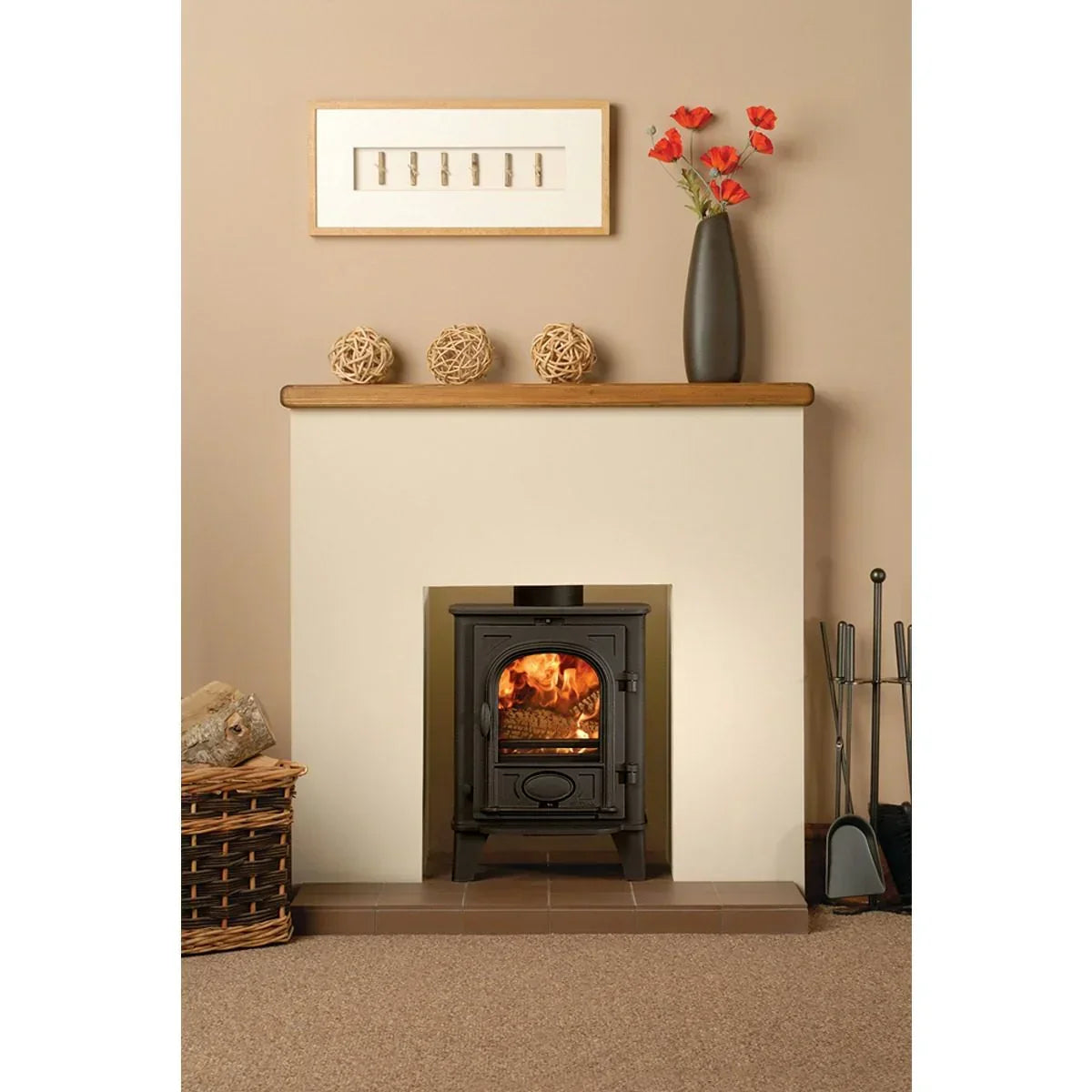 Black wood burning stove in modern fireplace with log basket and fireplace accessories
