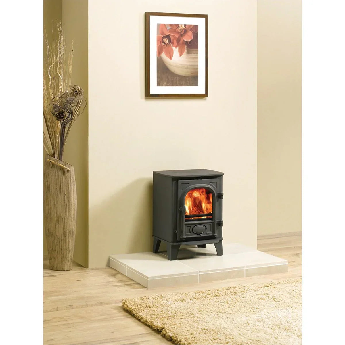Black wood burning stove on tiled hearth in modern living room with beige walls