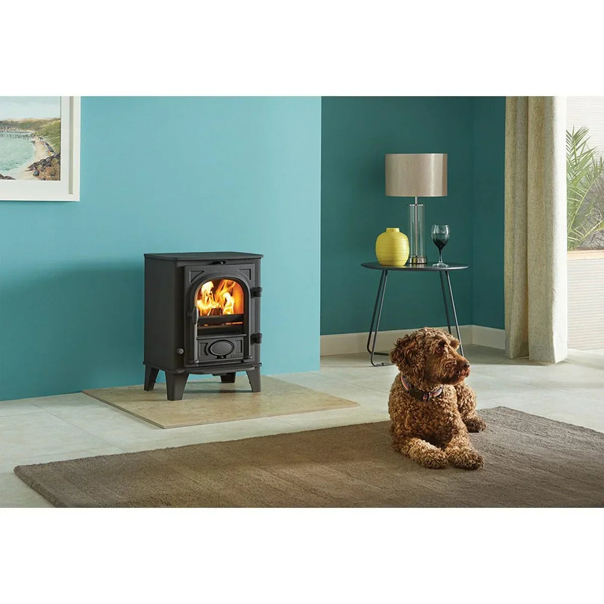 Black wood burning stove with flames in modern living room, dog lying on brown rug