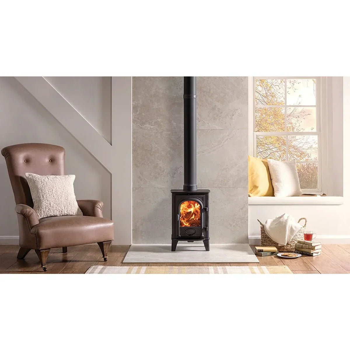 Wood burning stove in modern living room with brown armchair and window seat
