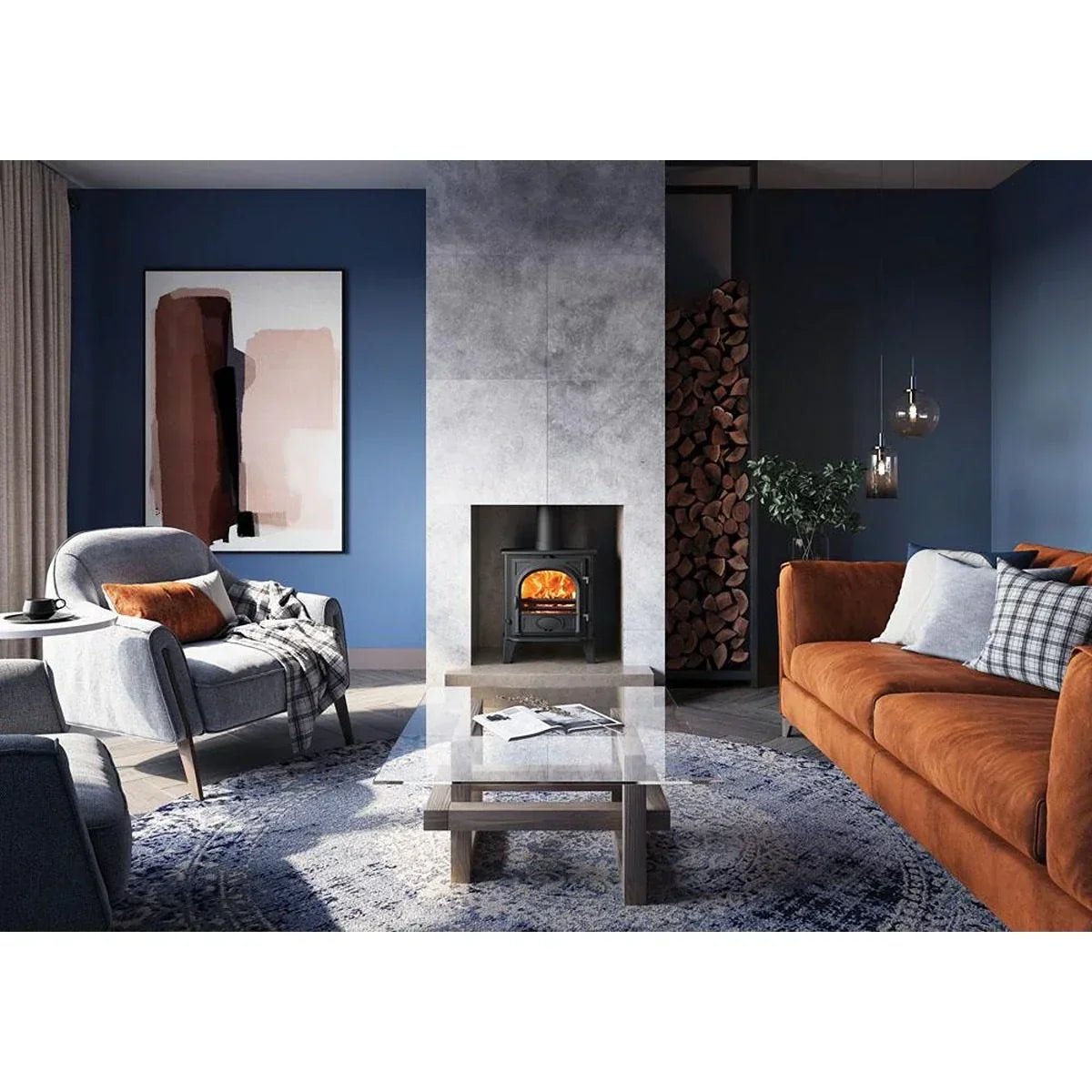 Modern living room with brown sofa, grey armchair, glass coffee table, and wood burning stove