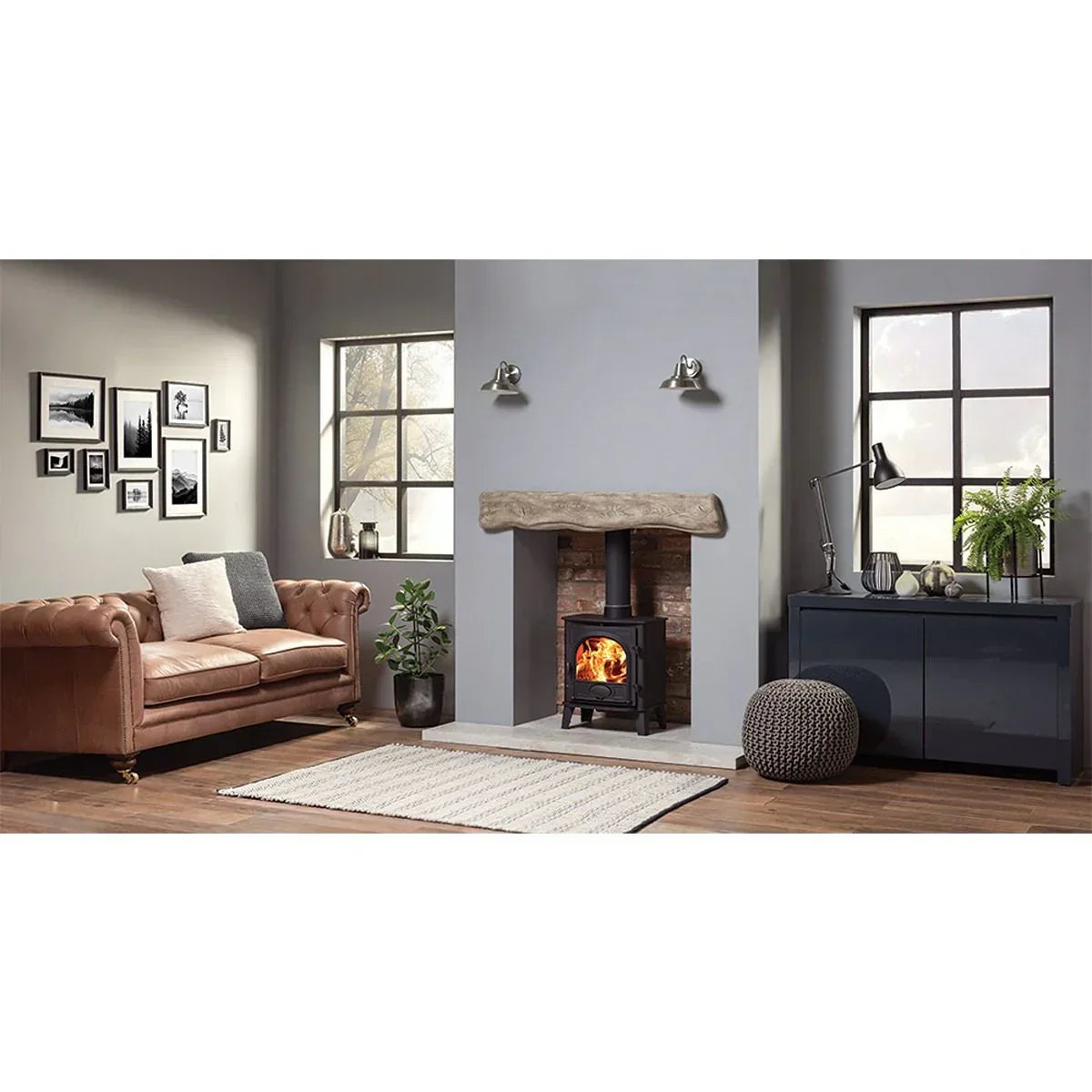 Brown leather chesterfield sofa and wood-burning stove in modern living room with grey rug