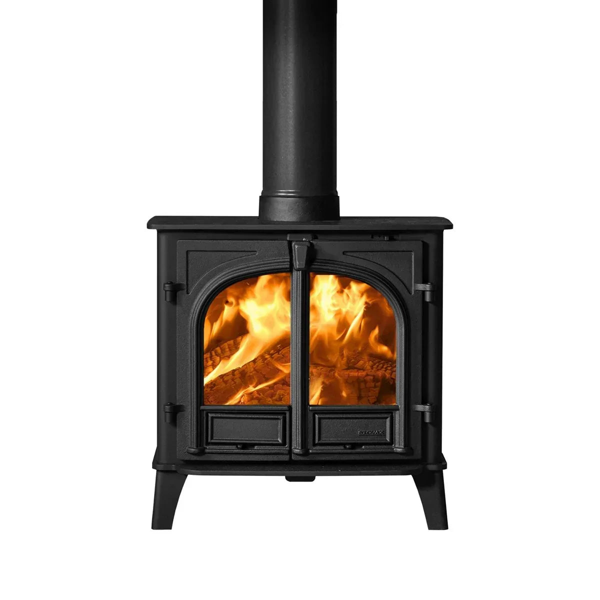 Black cast iron wood burning stove with glass doors and visible fire inside