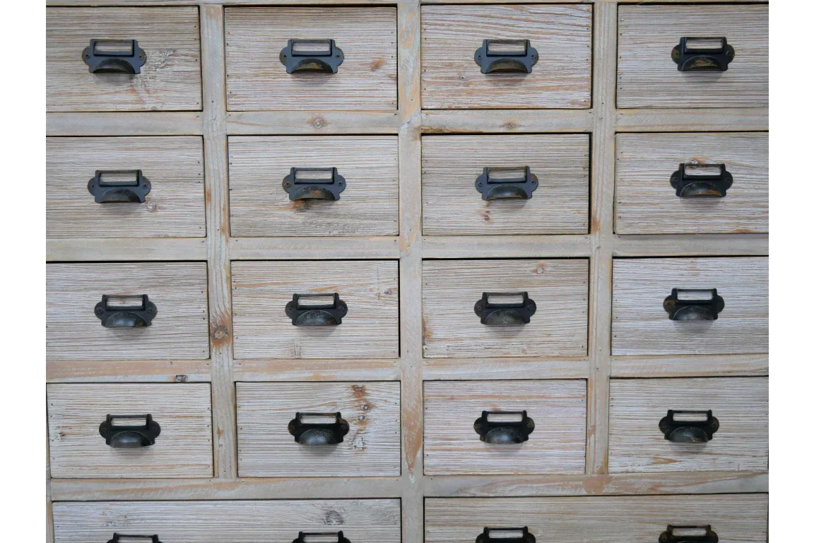 Rustic wooden drawer cabinet with metal handles and label frames, shown front on