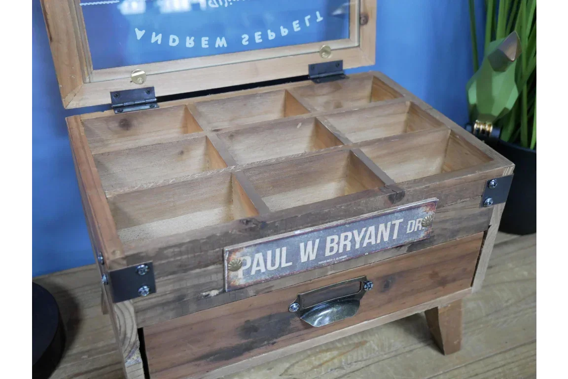 Wooden storage box with glass lid and compartmentalized organizer on tabletop