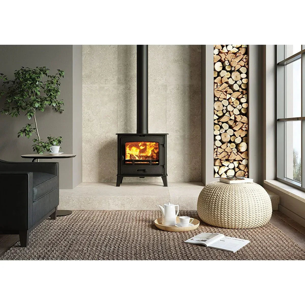 Black wood burning stove in modern living room with log storage, pouffe and coffee table