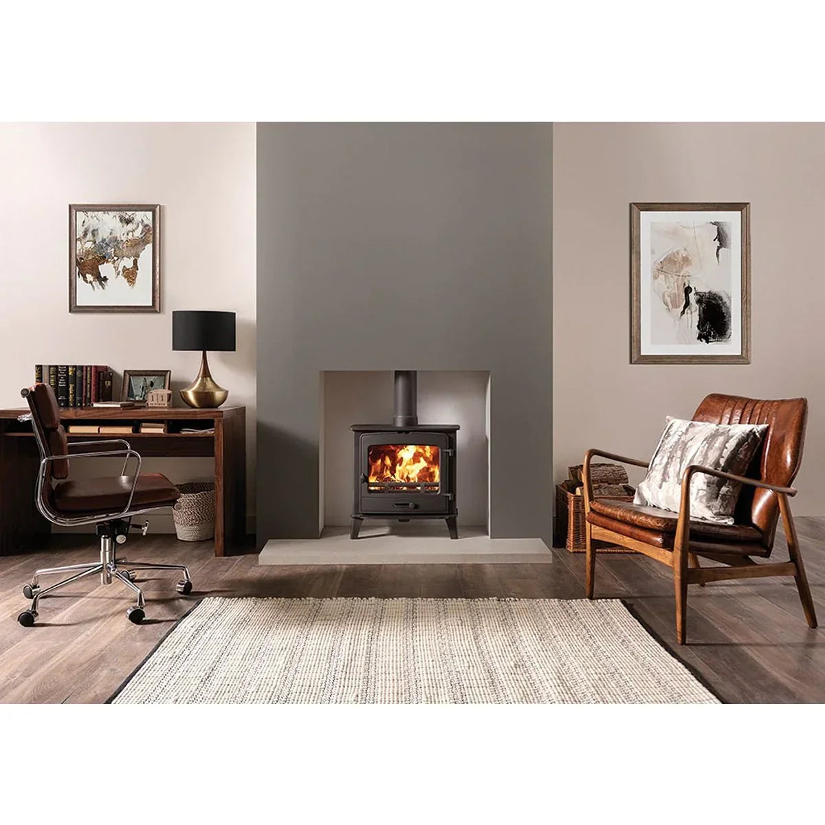 Leather armchair and wooden desk in living room with wood burning stove and neutral decor